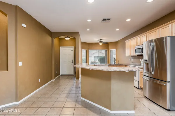 a kitchen with stainless steel appliances granite countertop a refrigerator and a stove