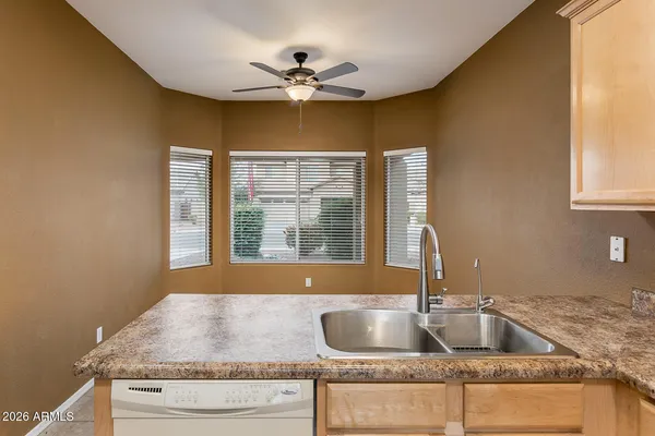 a kitchen with granite countertop a sink and a window