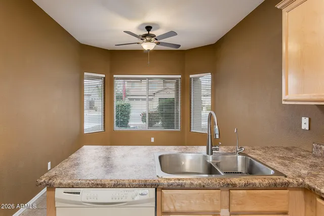 a kitchen with granite countertop a sink and a window