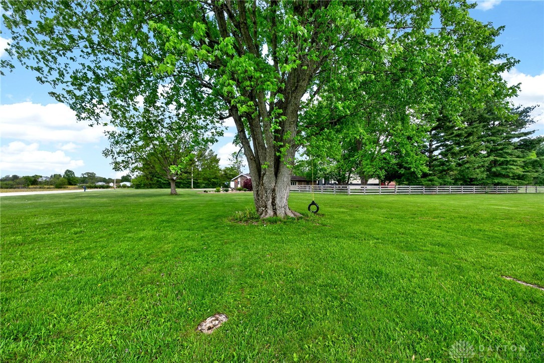 1005 Free Road New Carlisle, OH 45344 - Photo 34 of 43 Expansive green grounds offer a serene backdrop, perfect for outdoor enjoyment and relaxation.