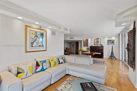 a view of a balcony with dining table and chairs