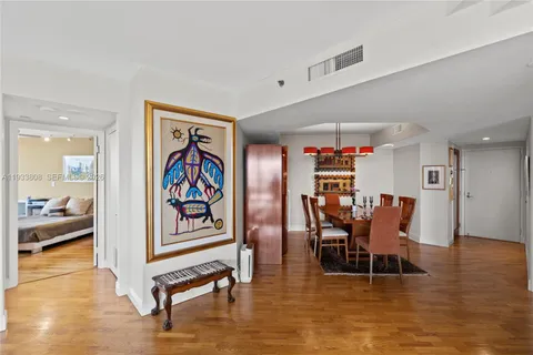 a living room with stainless steel appliances furniture and a window
