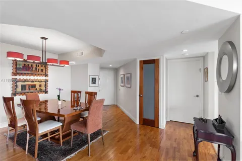 a bathroom with a granite countertop sink mirror vanity and toilet
