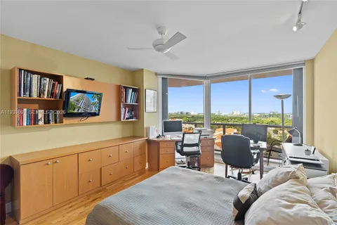 a view of a hallway with furniture and a refrigerator