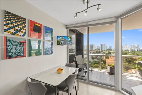 a living room with furniture windows and potted plants
