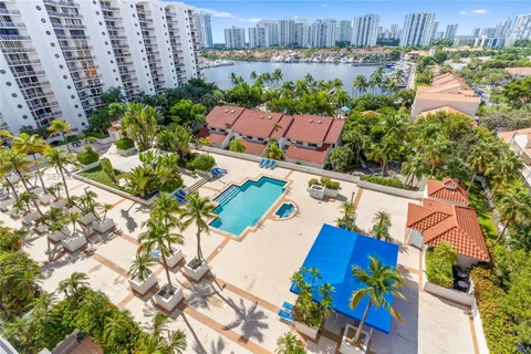 a spacious bedroom with a bed and a flat tv screen on a dresser