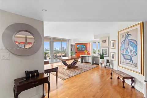 a living room with furniture and a large window with garden view