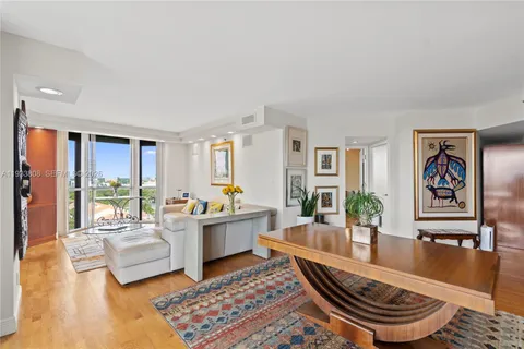 a living room with furniture and a large window with garden view