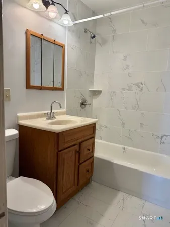 a bathroom with a sink a toilet and bathtub