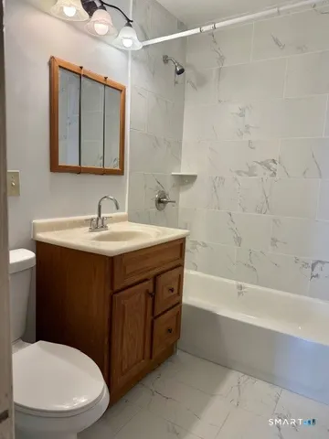 a bathroom with a sink a toilet and bathtub