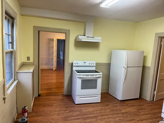 a kitchen with a refrigerator sink and cabinets