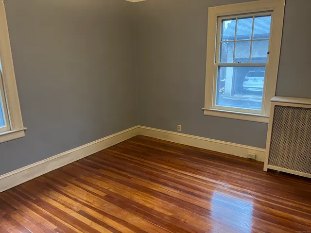 a view of a room with wooden floor and entryway