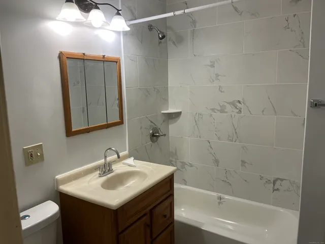 a bathroom with a sink toilet and shower