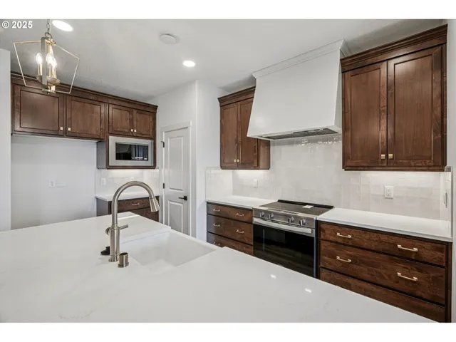 a kitchen with a sink appliances and cabinets
