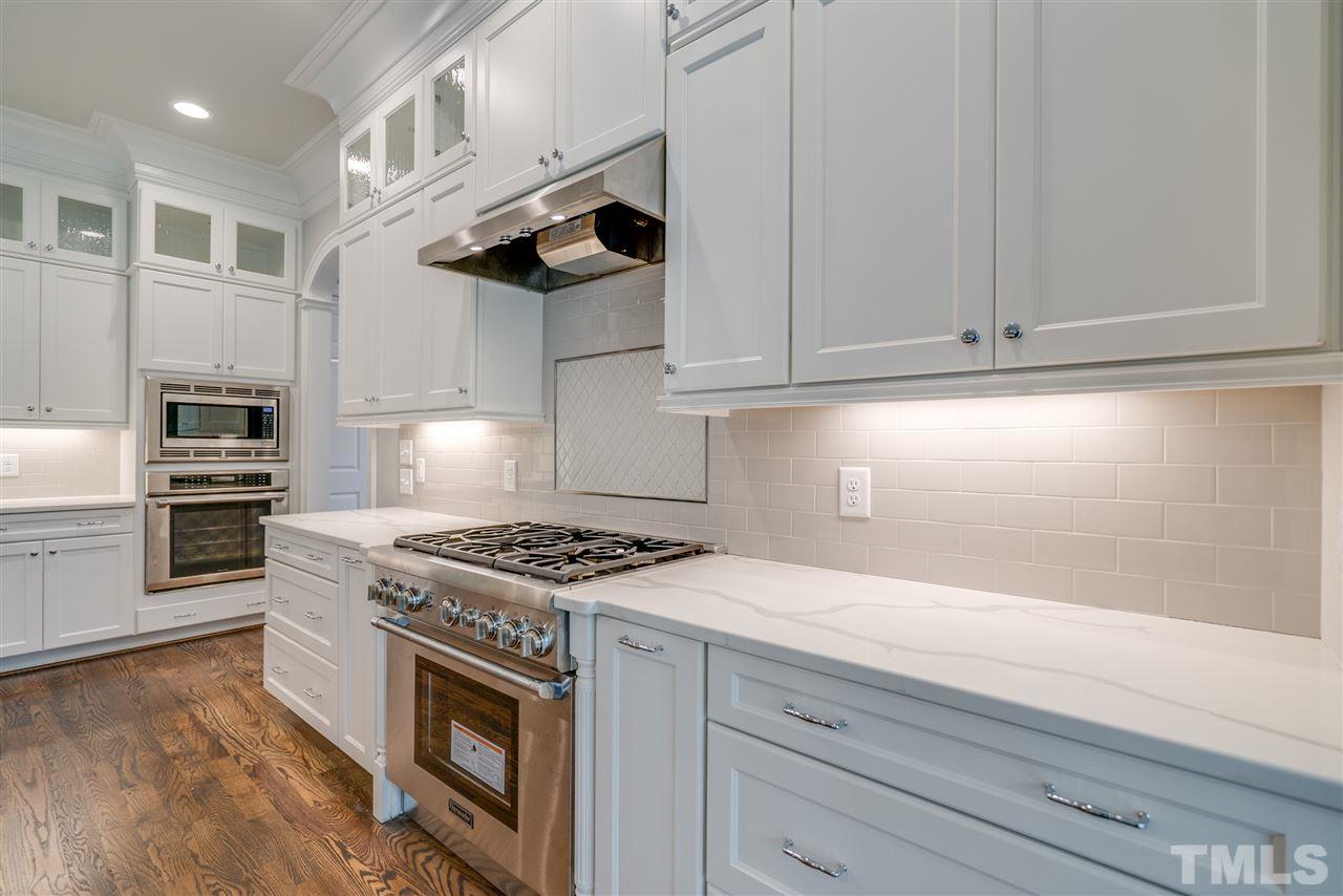 1508 Duplin Road Raleigh, NC 27607 - Photo 13 of 25 a kitchen with stainless steel appliances granite countertop a stove a sink and a microwave