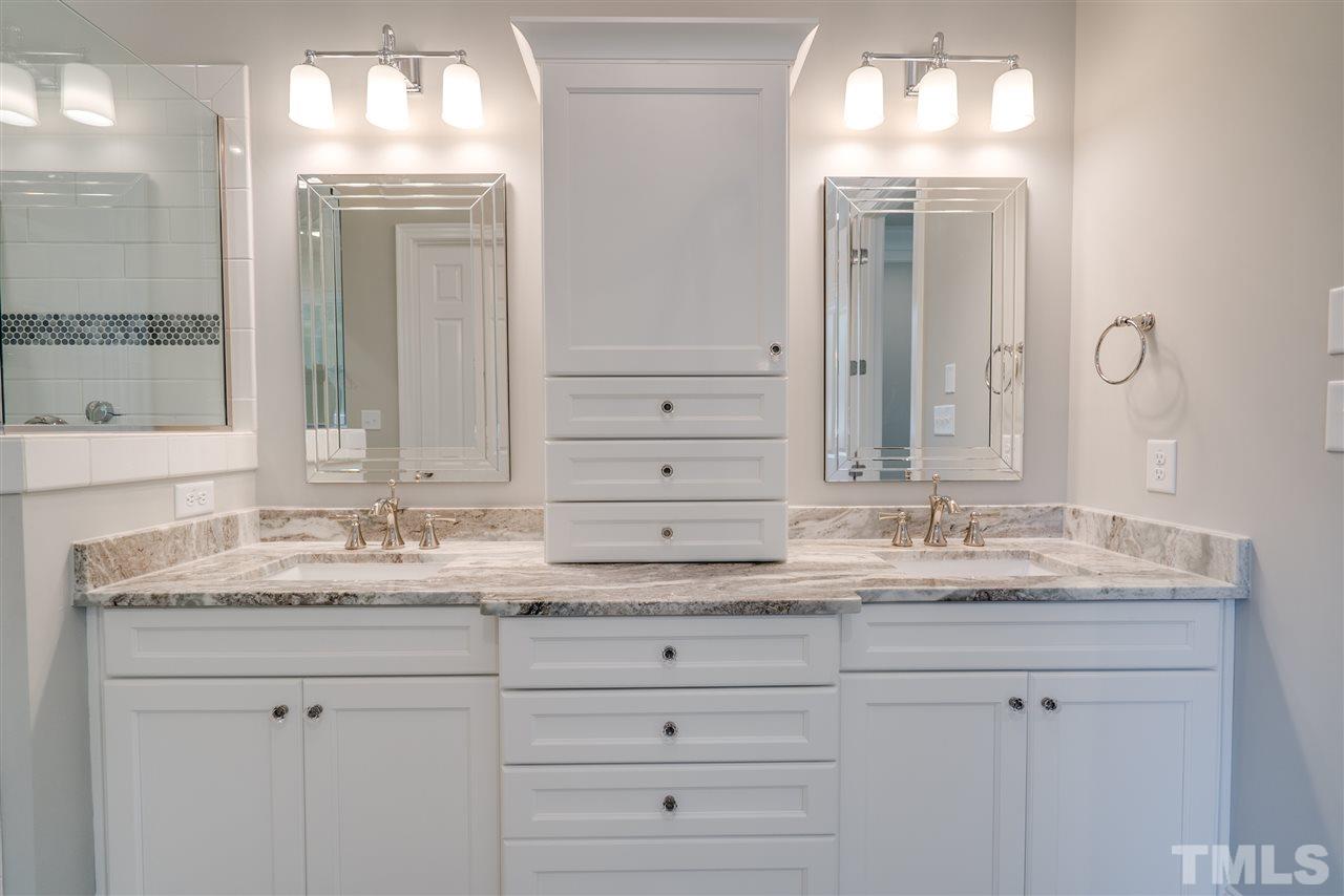 1508 Duplin Road Raleigh, NC 27607 - Photo 18 of 25 a bathroom with double vanity sinks and a mirror