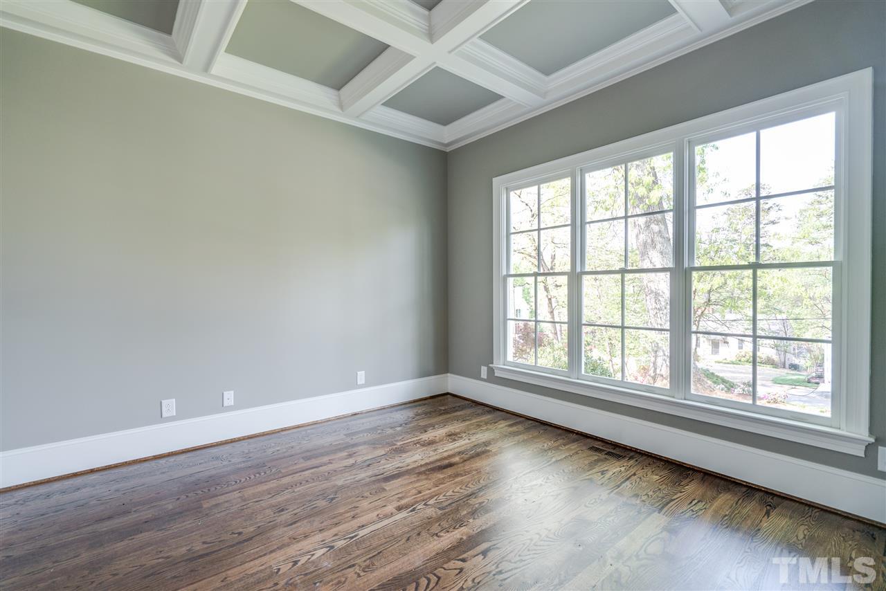 1508 Duplin Road Raleigh, NC 27607 - Photo 3 of 25 an empty room with wooden floor and windows