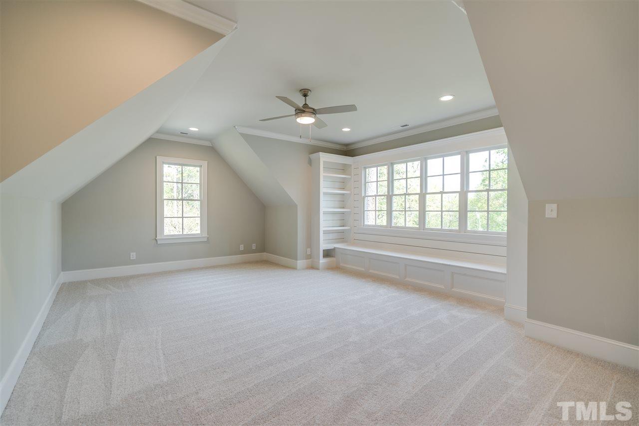 1508 Duplin Road Raleigh, NC 27607 - Photo 22 of 25 an empty room with chandelier fan and windows