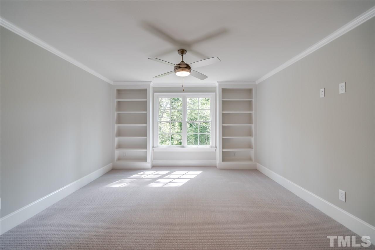 1508 Duplin Road Raleigh, NC 27607 - Photo 24 of 25 en empty room with windows and chandelier fan