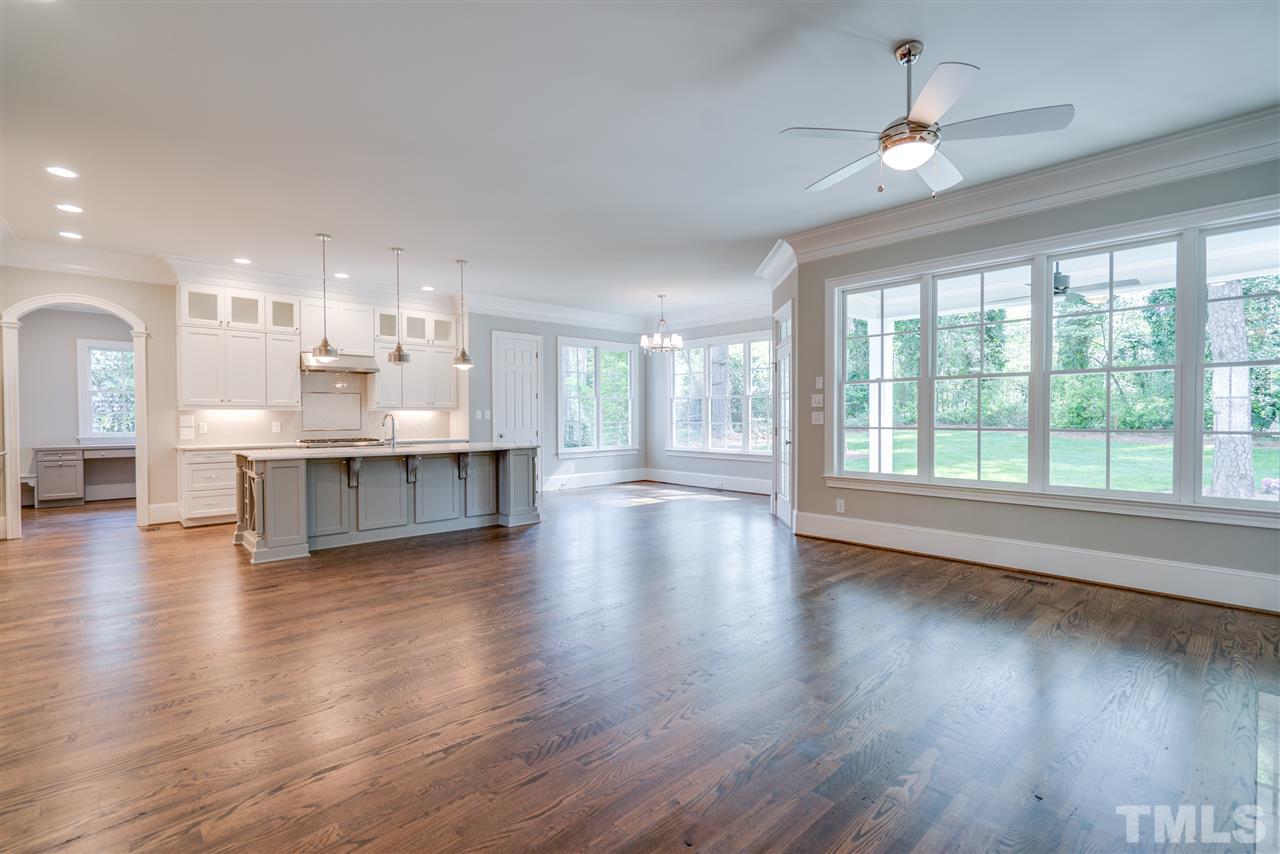 1508 Duplin Road Raleigh, NC 27607 - Photo 6 of 25 a view of an empty room with wooden floor and a large window