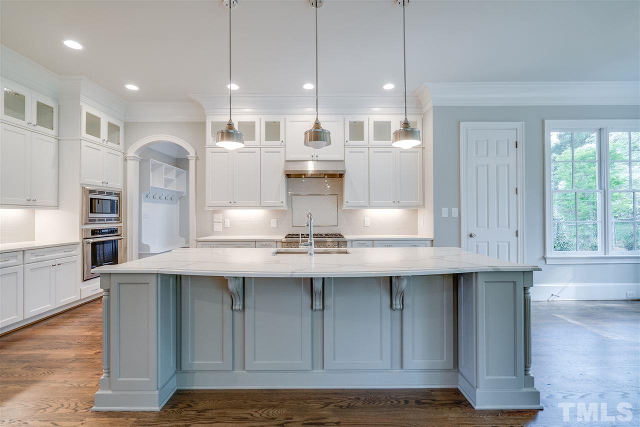 1508 Duplin Road Raleigh, NC 27607 - Photo 8 of 25 a kitchen with kitchen island granite countertop a sink cabinets and stainless steel appliances