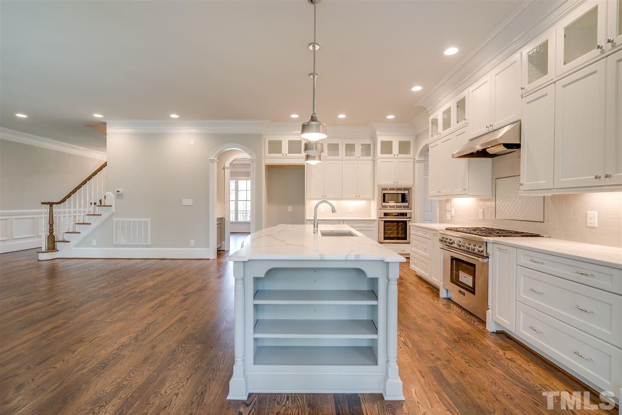 1508 Duplin Road Raleigh, NC 27607 - Photo 9 of 25 a kitchen with kitchen island a counter top space a sink stainless steel appliances and cabinets