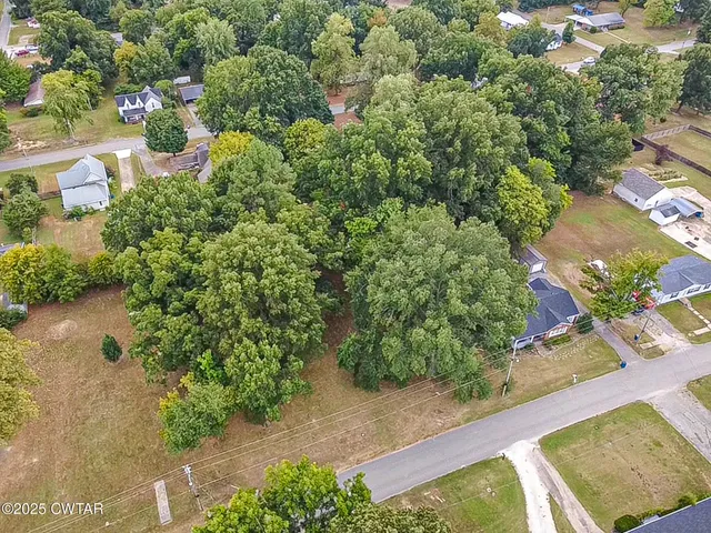 an aerial view of a house with a yard basket ball court and outdoor seating