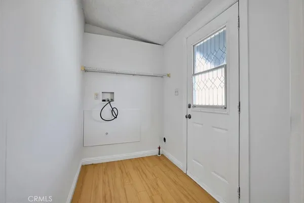 a view of room with window and wooden floor