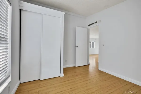 a view of an empty room and wooden floor