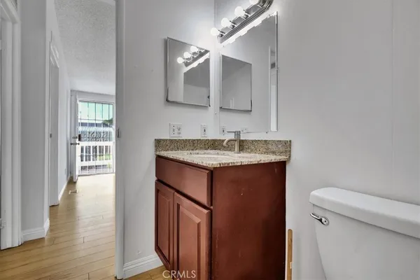 a bathroom with a sink toilet and mirror