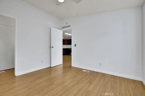 a view of an empty room with wooden floor