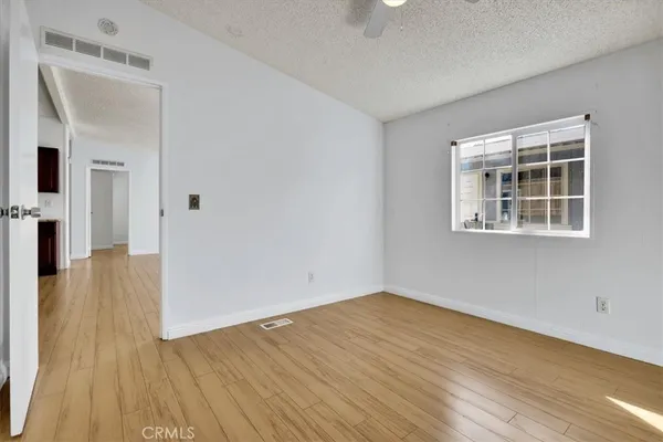 a view of empty room with wooden floor and wooden floor