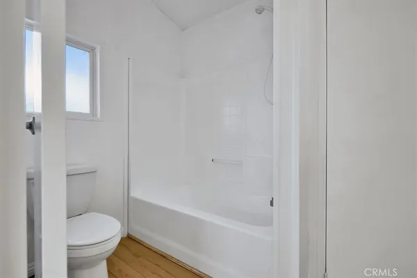 a bathroom with a toilet and a bathtub