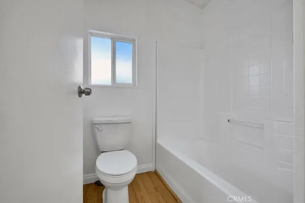 a bathroom with a toilet and a bathtub