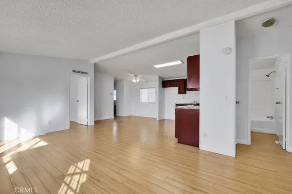 a view of an empty room and wooden floor