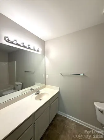 a bathroom with a toilet and a bathtub