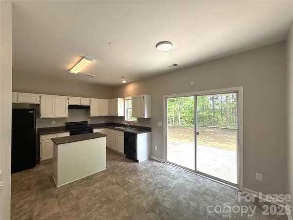 a kitchen with a sink and white appliances