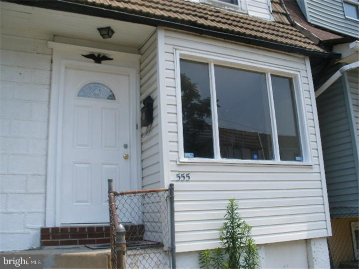 555 Millbank Road Upper Darby, PA 19082 - Photo 1 of 14 a front view of a house with a garage