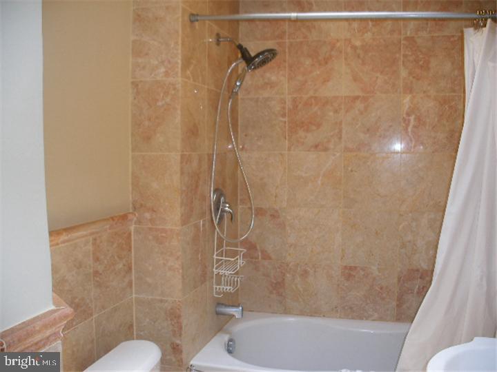555 Millbank Road Upper Darby, PA 19082 - Photo 12 of 14 a bathroom with a shower and a toilet