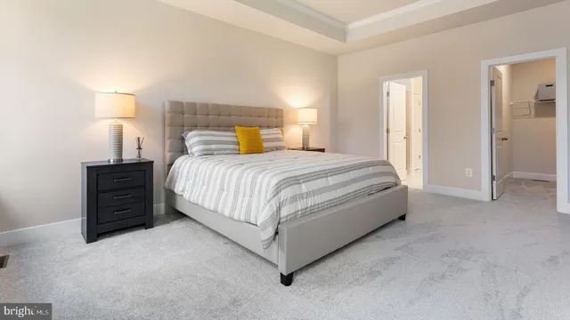 a bedroom with a bed and a lamp