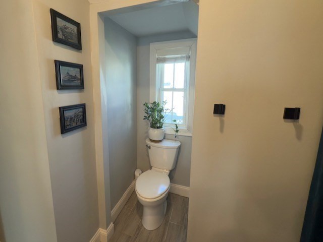 4 Cushing Street, Unit A Amesbury, MA 01913 - Photo 15 of 19 a white toilet sitting next to a small bathroom