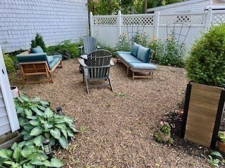 4 Cushing Street, Unit A Amesbury, MA 01913 - Photo 18 of 19 a view of a chair and table in backyard