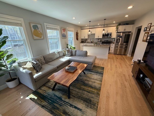 4 Cushing Street, Unit A Amesbury, MA 01913 - Photo 3 of 19 a living room with furniture and a wooden floor