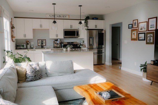 4 Cushing Street, Unit A Amesbury, MA 01913 - Photo 6 of 19 a living room with furniture and a flat screen tv