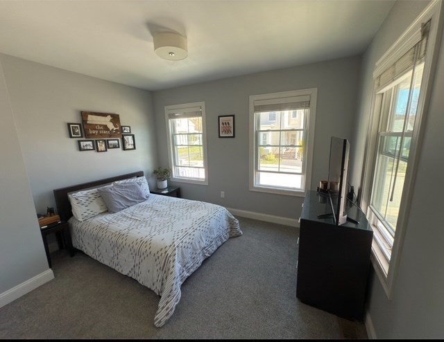 4 Cushing Street, Unit A Amesbury, MA 01913 - Photo 9 of 19 a bedroom with a bed and a window