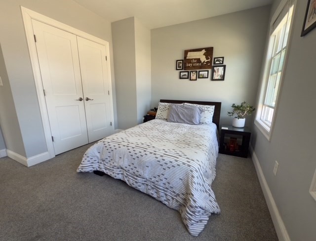 4 Cushing Street, Unit A Amesbury, MA 01913 - Photo 10 of 19 a bedroom with a bed and a painting on the wall
