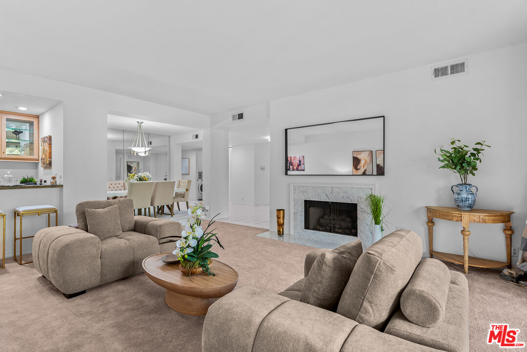 4736 Park Encino Lane, Unit 215 Encino, CA 91436 - Photo 11 of 37 a living room with furniture and a fireplace