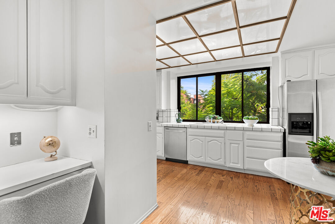 4736 Park Encino Lane, Unit 215 Encino, CA 91436 - Photo 14 of 37 a room with a window and a kitchen view