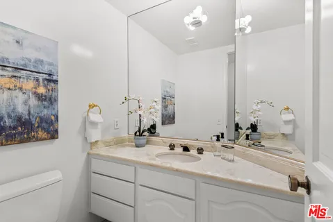 a spacious bedroom with a bed a fireplace and a large window