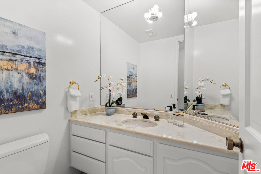 4736 Park Encino Lane, Unit 215 Encino, CA 91436 - Photo 17 of 37 a bathroom with a sink and a mirror